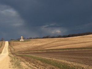Dark clouds over farmland.