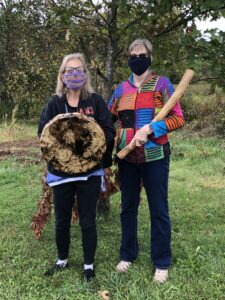 Two women with drum and rain stick