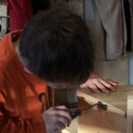Boy tightens a screw