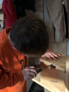 Boy tightens a screw