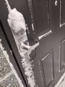 Snow on security door.