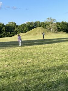 Visitors regard tall Mounds.