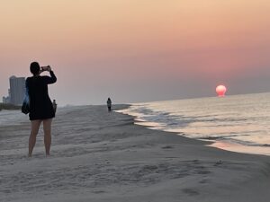 Red sunrise and person taking picture