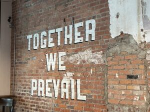 Sign on wall: together we prevail