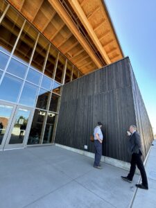 Dean Becker and Rich examine outside of Idaho Central Credit Union Arena Building, Moscow, Idaho.