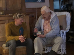 Grandpa gifting Penn Senator reel to grandson.