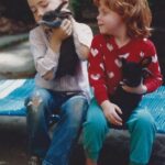 Two children with their domestic rabbits