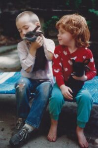 Two children with their domestic rabbits