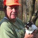 Man holding a Rex rabbit