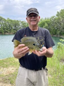 Man holding bluegill