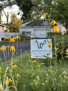 Winding Pathways sign and prairie flowers.