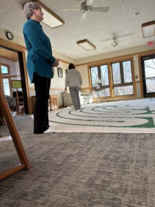 Walkers on an indoor labyrinth at Prairiewood Spirituality Center, Hiawatha, IA.