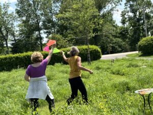 Women use playful scarves to Appleton Dance in Phoenix Harmony Labyrinth.