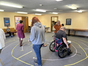 People use wheelchairs and feet to move through the indoor labyirnth.