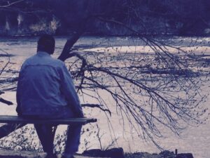 Man sitting by water.